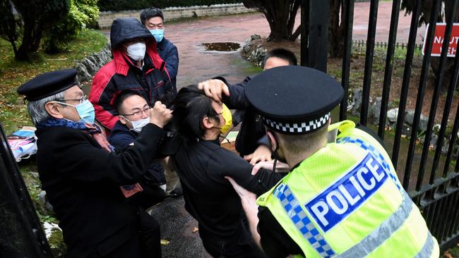 Zheng Xiyuan, left, oversees the roughing up of ‘Bob’ outside the Chinese consulate in Manchester this week. Picture: AFP