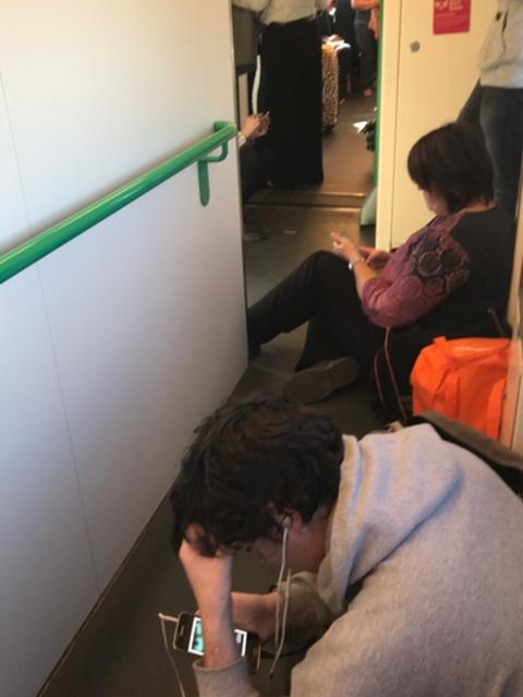 Commuters sitting on the floor on a crowded train. Picture: Supplied