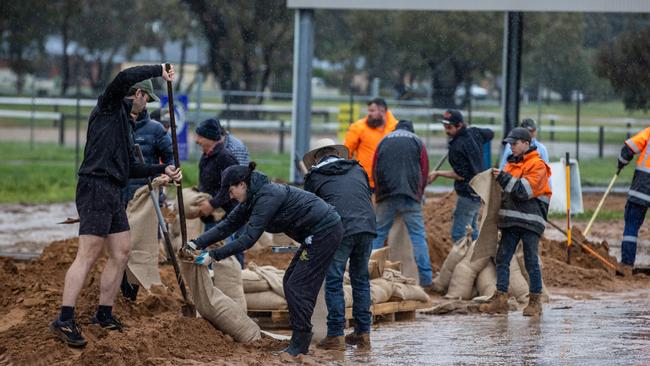 The small town of Rochester on the Campaspe River prepares for rising flood waters, filing sand bags and waterproofing shop fronts. Picture: Jason Edwards