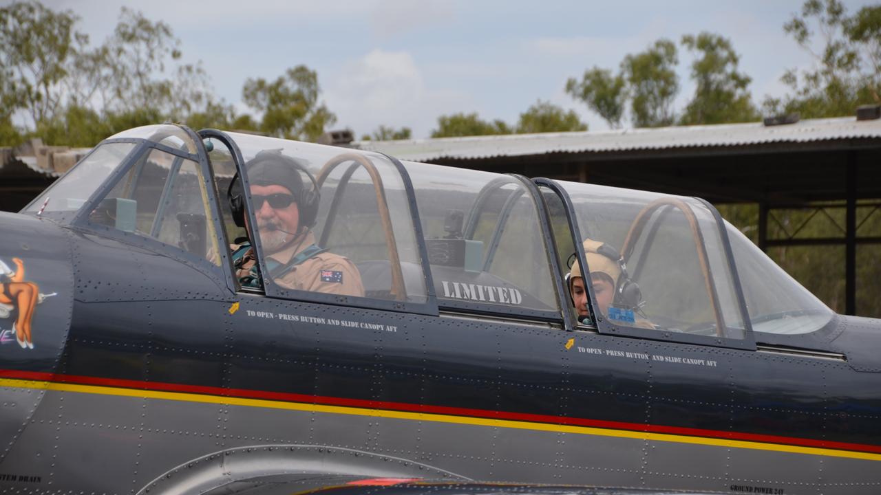 Former RAAF pilot Pete Marris prepares to take passenger Marly Page, 13, into the air in the Yak-52 warbird plane.