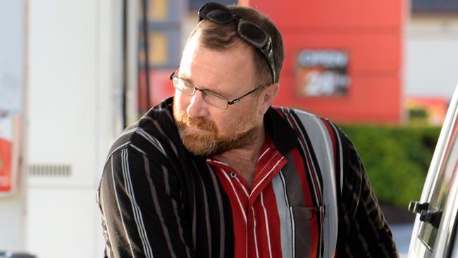 Carl Smith fills up at a servo on West Tce. Pic: Greg Higgs