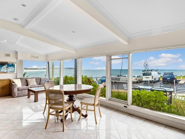 Floor-to-ceiling glass looking out to sea.