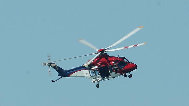 A rescue helicopter patrols Moreton Bay during a search effort. Photo: Claudia Baxter.