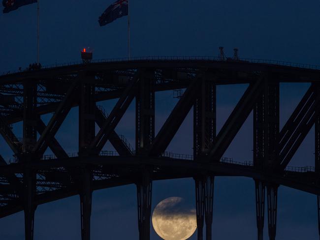 A full moon is seen rising behind the Sydney Harbour Bridge, in Sydney, Monday, Nov. 14, 2016. Picture: AAP Image/Dan Himbrechts