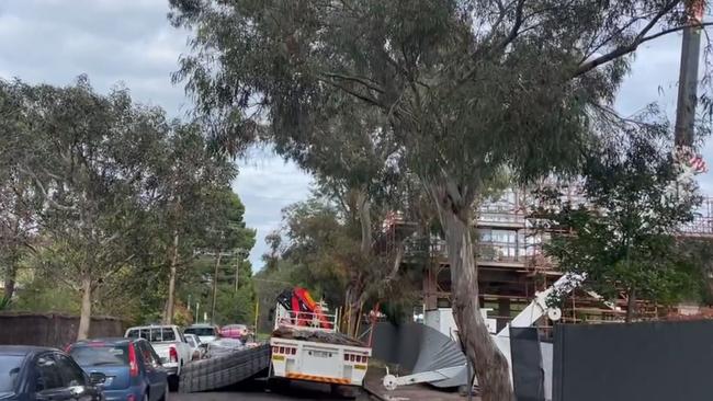 Bertram Street at Hackney is closed in both directs after a crane’s main boom has snapped and dropped its load onto nearby parked cars. picture Nine News