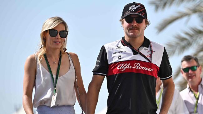 Alfa Romeo's Finnish driver Valtteri Bottas arrives to the track with his girlfriend, pro cyclist Tiffany Cromwell, before the third practice session ahead of the Abu Dhabi Formula One Grand Prix at the Yas Marina Circuit in the Emirati city of Abu Dhabi on November 19, 2022. Picture: Ben Stansall / AFP