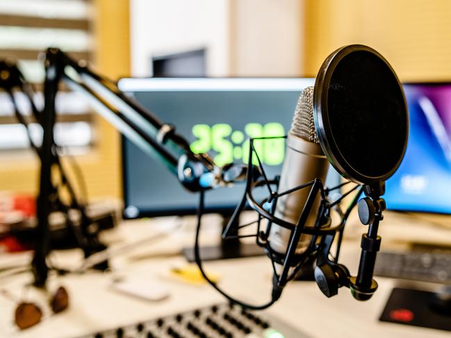 Microphone and mixer at the radio station studio broadcasting news. iStock