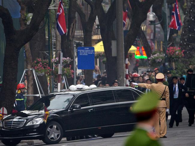 Body guards run behind the motorcade of North Korean leader Kim Jong Un as he return to Melia hotel Hanoi, Vietnam. Picture: AP 