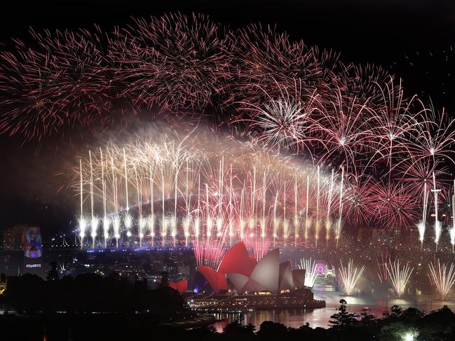 The midnight fireworks with Sydney’s iconic Opera House and Harbour Bridge taking centre stage as seen from a rooftop in Potts Point. Picture: Toby Zerna