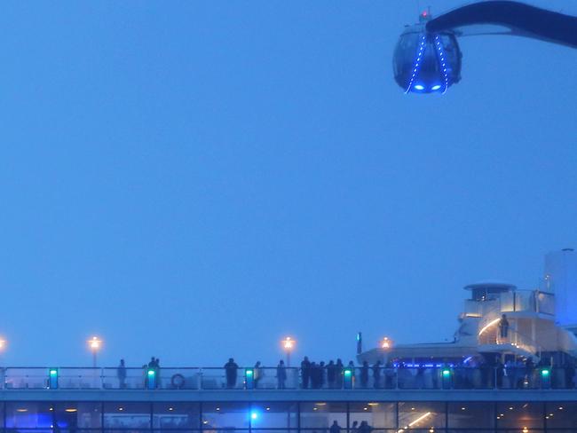 Passengers gathered on the deck as the Ovation of the Seas passed the heads. Picture: John Grainger