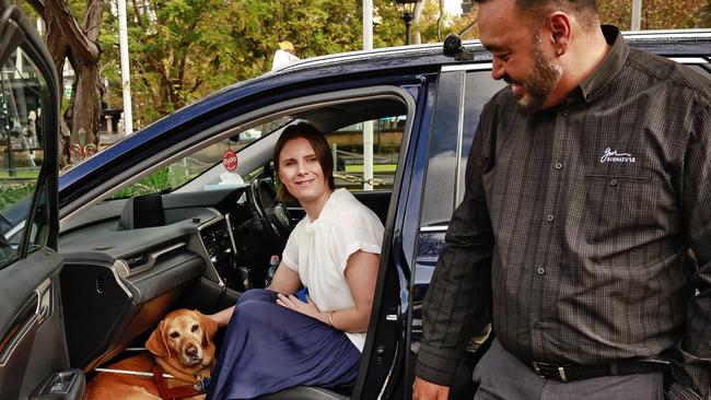 Sarah Hirst and her guide dog Zali with taxi driver Shawon Bar at Central Station in Sydney. Picture: Sam Ruttyn