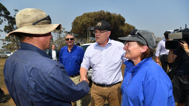 Scott Morrison meets property owners Simon and Madelyn Kelly during his visit to a fire-damaged property on Kangaroo Island on Wednesday. Picture: AAP