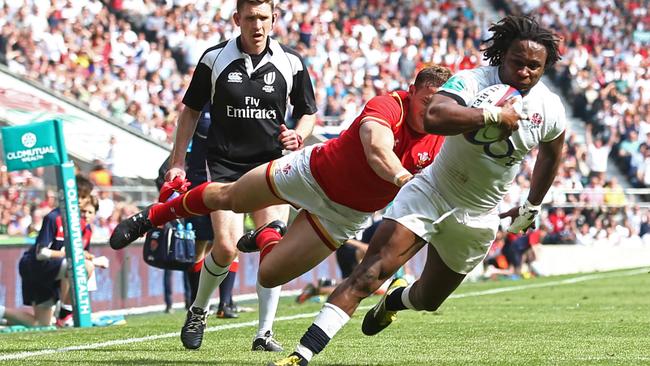 England's wing Marland Yarde (R) goes over to score a try against Wales at Twickenham Stadium.