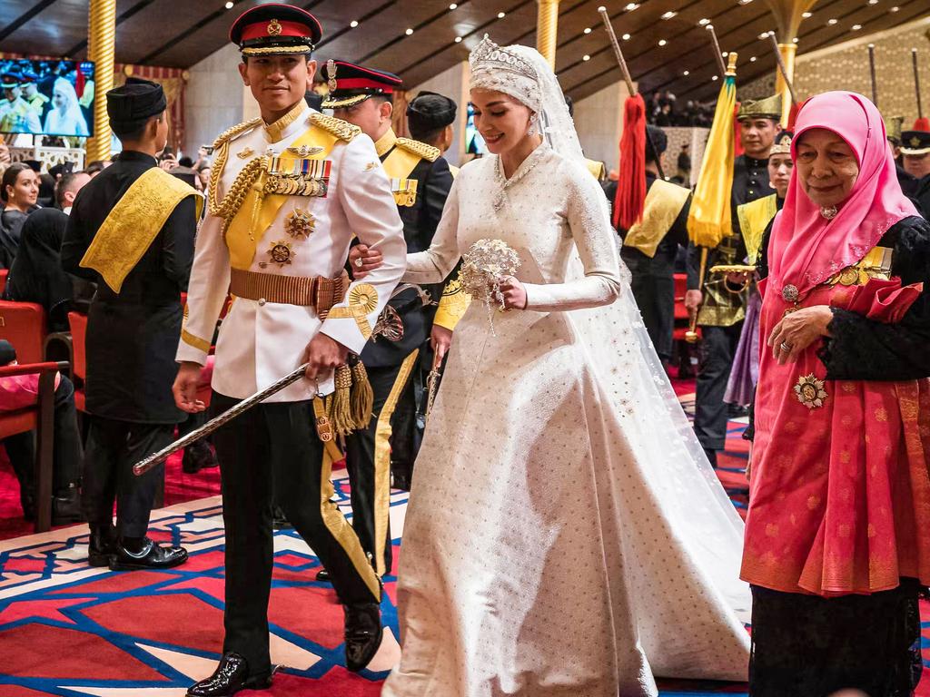 Prince Abdul Mateen and Anisha Rosnah walk down the aisle. Picture: AFP