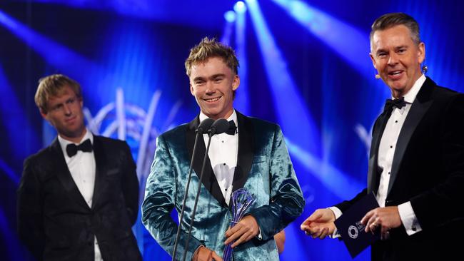 Hayden Jones is presented with the Male Junior Athlete of the Year award as he speaks with Todd Woodbridge on stage during the 2024 Newcombe Medal. Photo by Graham Denholm/Getty Images for Tennis Australia