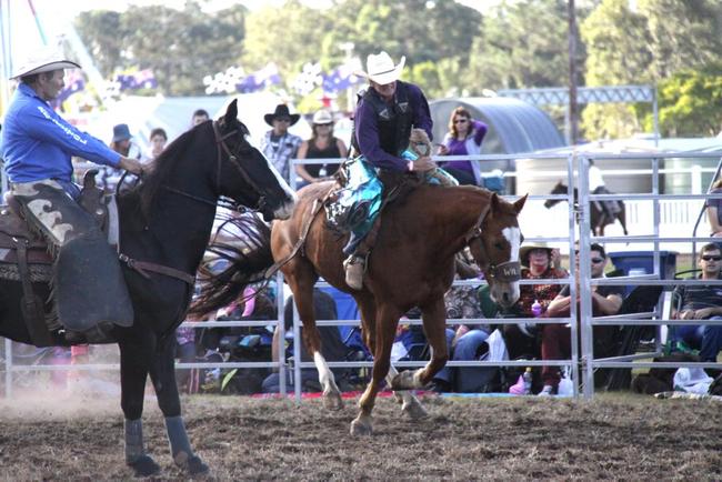 Bruce Pitt works hard on his saddle bronc ride at the Gympie Show.
