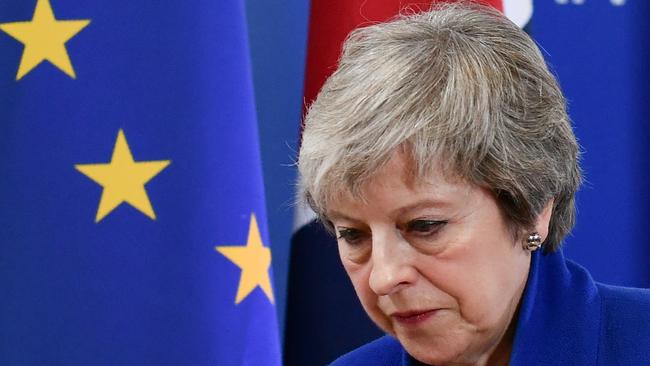 Britain's Prime Minister Theresa May leaves after a press conference following a special meeting of the European Council to endorse the draft Brexit withdrawal agreement.