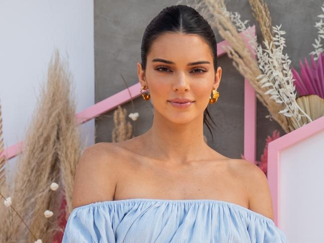 LA QUINTA, CALIFORNIA - APRIL 14: Kendall Jenner is seen wearing blue off shoulder dress, gloves with print, green sock boots at Revolve Festival during Coachella Festival on April 14, 2019 in La Quinta, California. (Photo by Christian Vierig/Getty Images)