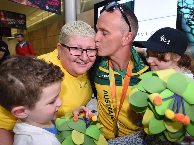 Paralympic rower Erik Horrie is welcomed by his family at Sydney International Airport after arriving home from the 2016 Rio Paralympics. Picture: AAP/Dean Lewins