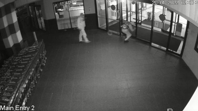 Two people are captured breaking into Pemulwuy Marketplace on January 20, 2022 at 2.07am. The man at the door is allegedly Darren Hookey.