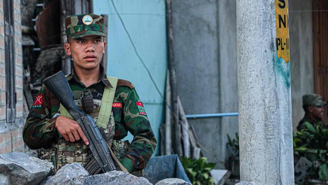 A fighter of the ethnic armed group Ta'ang National Liberation Army stands guard in the town of Namhkam, in northern Shan state. Picture: AFP