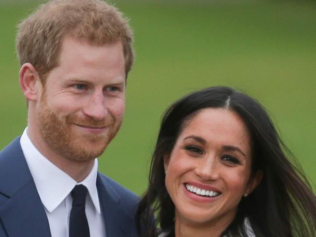 (FILES) In this file photo taken on November 27, 2017 Britain's Prince Harry and his fiancÃ©e US actress Meghan Markle pose for a photograph in the Sunken Garden at Kensington Palace in west London on November 27, 2017, following the announcement of their engagement. - Prince Harry and wife Meghan blamed "viper" courtiers' for widening their rift with the royal family, according to extracts from a new book published in The Times on Saturday. (Photo by Daniel LEAL-OLIVAS / AFP)