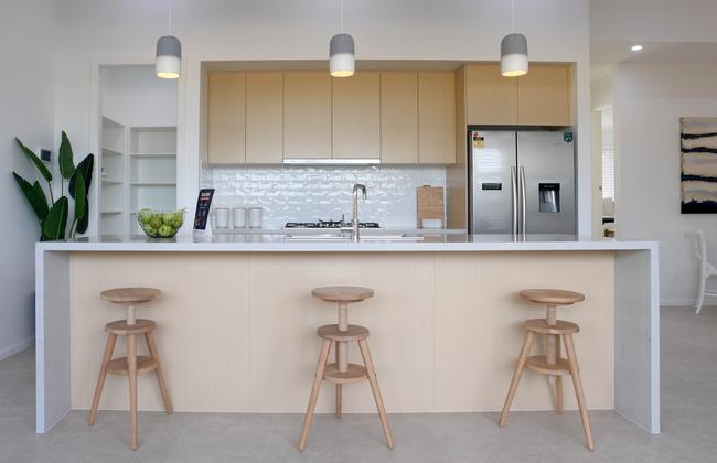 The kitchen with island bench and walk-in pantry.