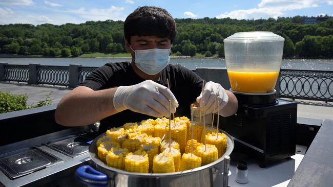 A bartender prepares food at an outdoor bar counter in central Moscow. Picture: AFP