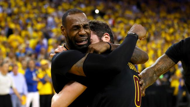 LeBron James hugs Kevin Love after securing a historic NBA championship for Cleveland.