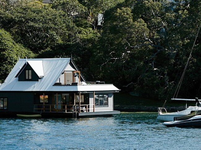 This neighbouring Pearl Bay houseboat, once owned by John Singleton, has been restored into a luxury floating home.