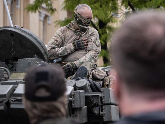 A member of Wagner group gestures as he sits atop of a tank in a street in the city of Rostov-on-Don. Picture: Roman Romokhov