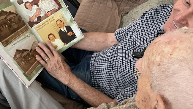Polish immigrant Jozef Pilarski looking through memories with his son Kas. Supplied.