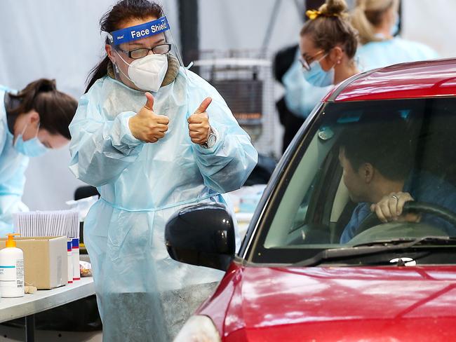 IPC Health conducts COVID-19 testing at Keilor Community Hub in Keilor.A nurse gives a motorist the thumbs up after his test. Picture : Ian Currie