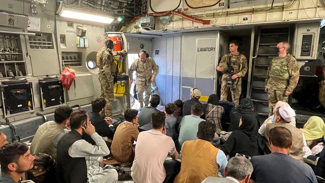 US Marine Corps Gen. Frank McKenzie, the commander of US Central Command, speaks to locals at Hamid Karzai International Airport in Kabul. Picture: AFP.