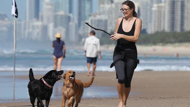Bianca Andersen with her two dogs Bailey (black) and Lily (Tan) at The Spit. Picture: Mike Batterham.