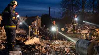 Rescuers search for bodies amid the ruins of the cafe, which was targeted thanks to information supplied by Volodymyr Mamom and his brother Dmytro. Picture: Getty Images