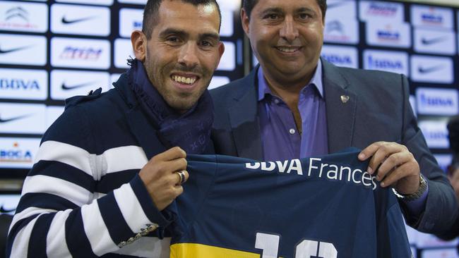 Carlos Tevez poses in Manchester United shirt