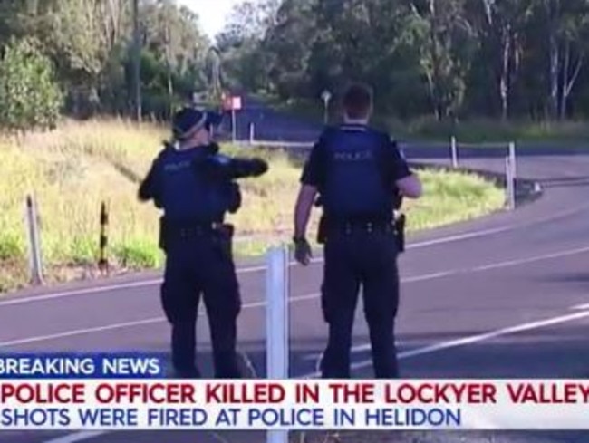 A police officer has died after being shot whole pursuing a wanted man in regional Queensland.