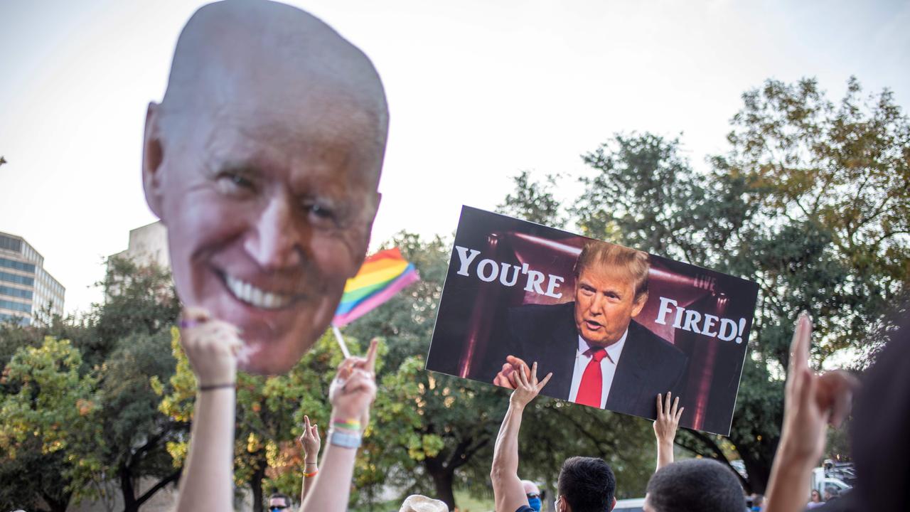 TOPSHOT - Supporters of US President-elect Joe Biden gather near the Texas capitol building to celebrate his victory in the 2020 presidential election in Austin, Texas. Democrat Joe Biden has won the White House, US media said November 7, defeating Donald Trump and ending a presidency that convulsed American politics, shocked the world and left the United States more divided than at any time in decades. (Photo by Sergio FLORES / AFP)