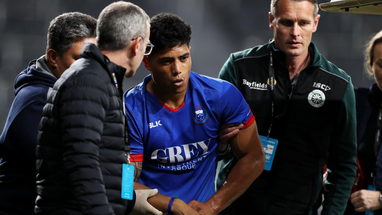 Scott Malolua of Samoa is helped to a medicab with injury at Bankwest Stadium.