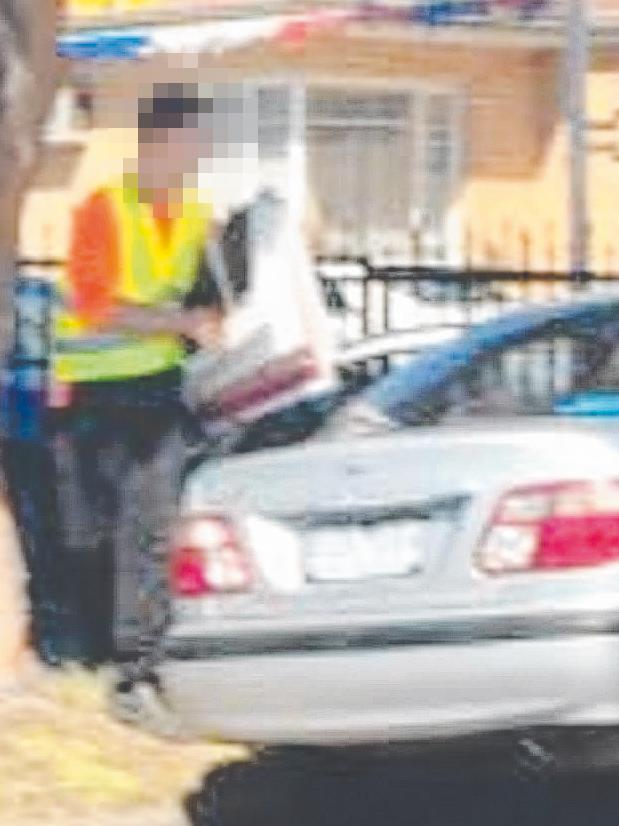 A man is seen allegedly taking down promotional posters for independent candidate Darryn Lyons on Thursday, October 25. Picture: Submitted