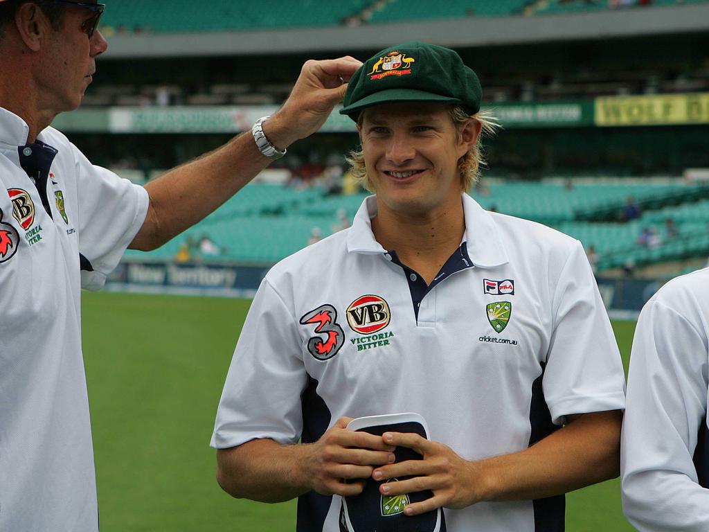 John Buchanan gives Shane Watson a hand with his first baggy green cap.