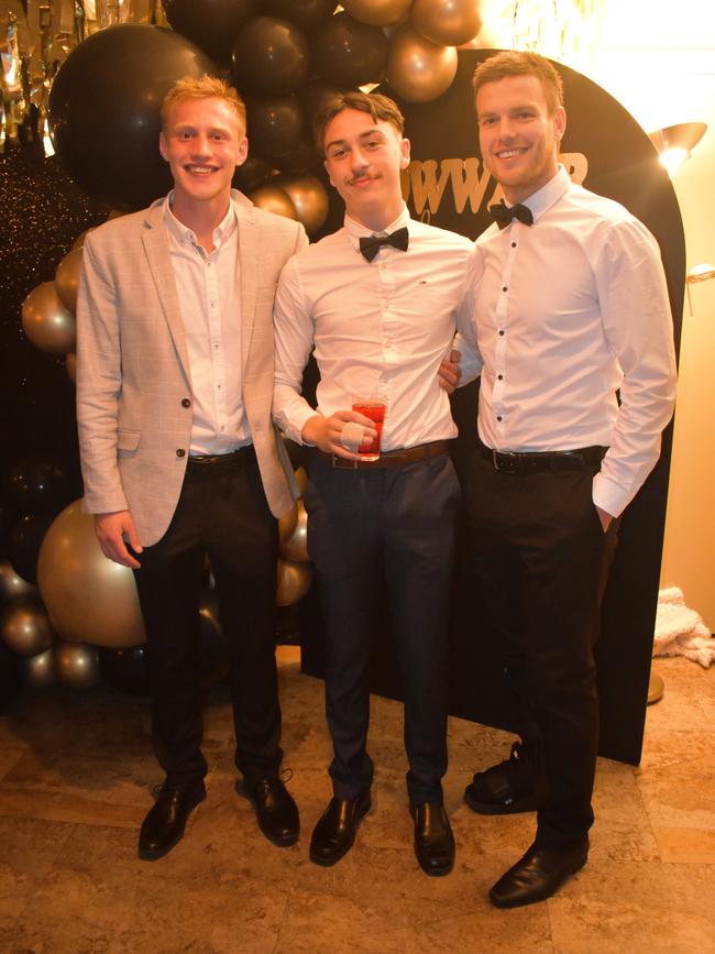 Rhys Luxford, Jake Brown and Ben Coffey having a great night at the Cowwarr Saints Football &amp; Netball Club Golden Gala Ball 2024. Picture: Jack Colantuono