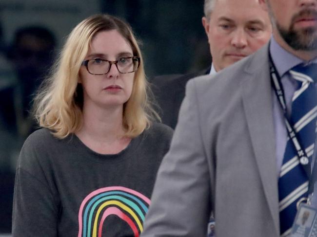 ADELAIDE, AUSTRALIA - NewsWire Photos 24,November, 2023: Lisa Lines escorted by police after being extradited back to Australia on charges of attempted murder of her husband. Picture: NCA NewsWire / Kelly Barnes