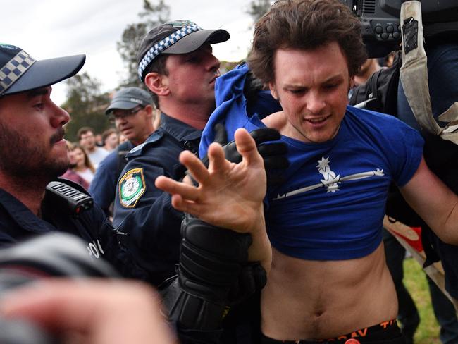 Police forced protesters back before the talk began. Picture: AFP