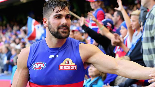 MELBOURNE, AUSTRALIA - MARCH 27: Marcus Adams of the Bulldogs high fives fans after winning the round one AFL match between the Western Bulldogs and the Fremantle Dockers at Etihad Stadium on March 27, 2016 in Melbourne, Australia. (Photo by Quinn Rooney/Getty Images)