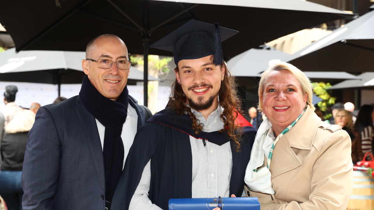 Deakin graduate Jonah Taylor with parents Brett and Lyndall. Picture: Alison Wynd