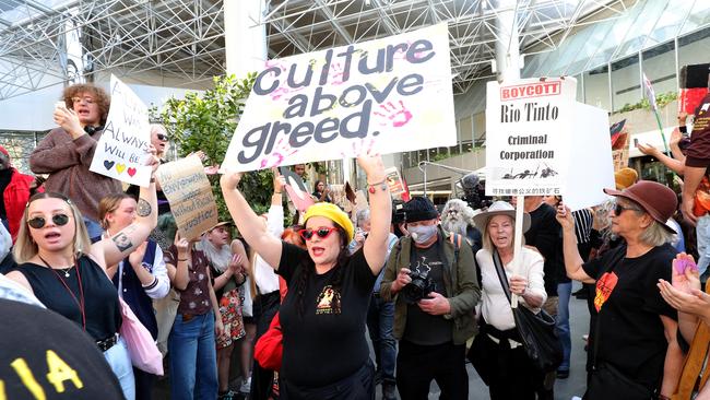 Protesters are seen during a rally outside the Rio Tinto office in Perth. Picture: AAP Image/Richard Wainwright.