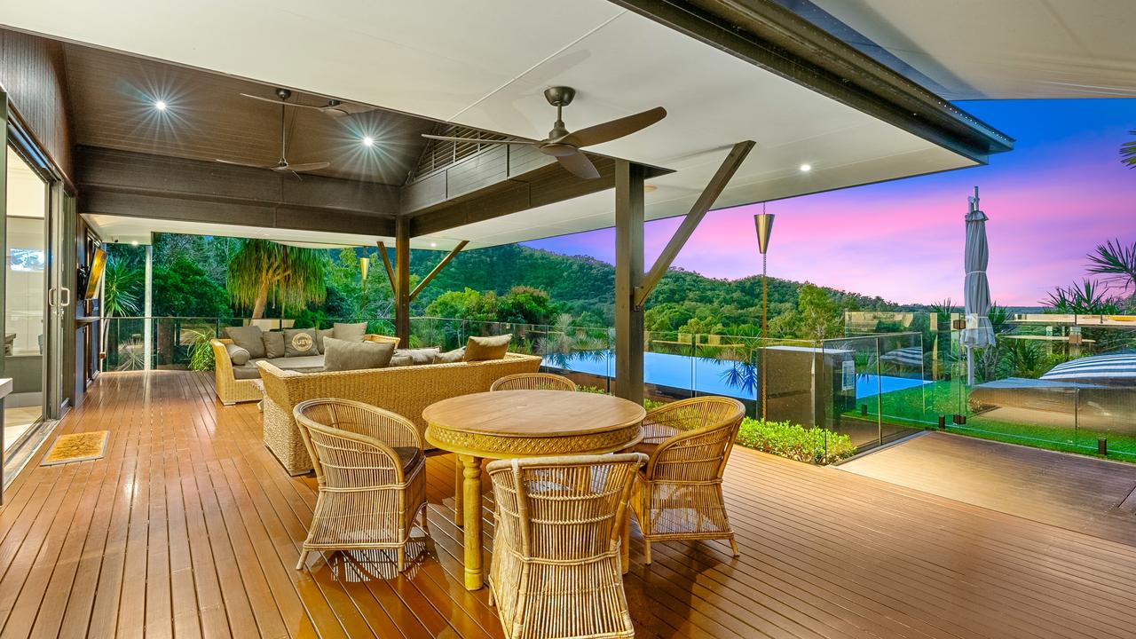 The retreat sits at the highest point of the holding surrounded by tropical rainforest with views from the entertaining deck, which has a wet edge pool and pizza oven. Picture: Supplied