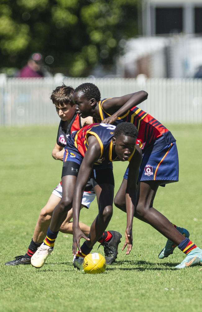 Moses Amreis gets possession for University Cougars against South Toowoomba Bombers in AFL Darling Downs under-14 mixed grand final at Rockville Park, Saturday, August 31, 2024. Picture: Kevin Farmer